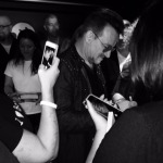 That’s my pouf of hair just to the right of Bono as he signs my U2 paraphernalia. The next photo is the one visible in the iPhone. (Photo: Allen Cueli)